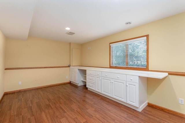 2045 Roberta Dr, North Mankato, MN 56003 - spare room with built in study area, wood finished floors, and recessed lighting