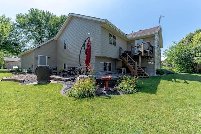 2045 Roberta Dr, North Mankato, MN 56003 - rear view of house with a deck, stairway, a patio, and a lawn