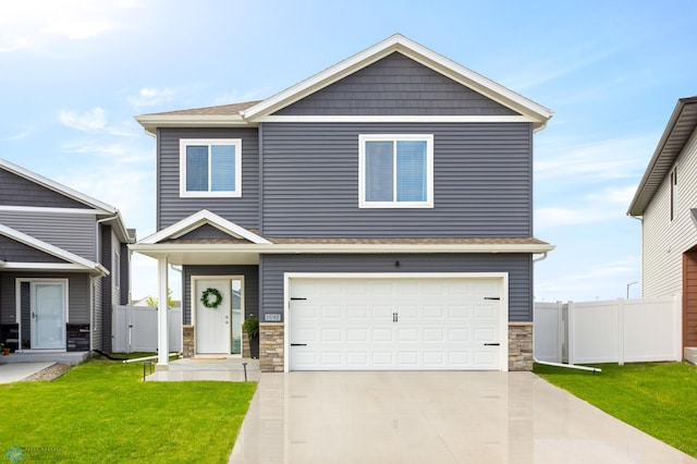 1592 69th Ave S, Fargo, ND 58104 - view of front of home with a garage, concrete driveway, and stone siding