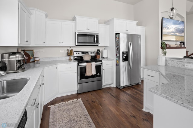 1592 69th Ave S, Fargo, ND 58104 - kitchen with stainless steel appliances, dark wood-type flooring, white cabinets, and light stone countertops