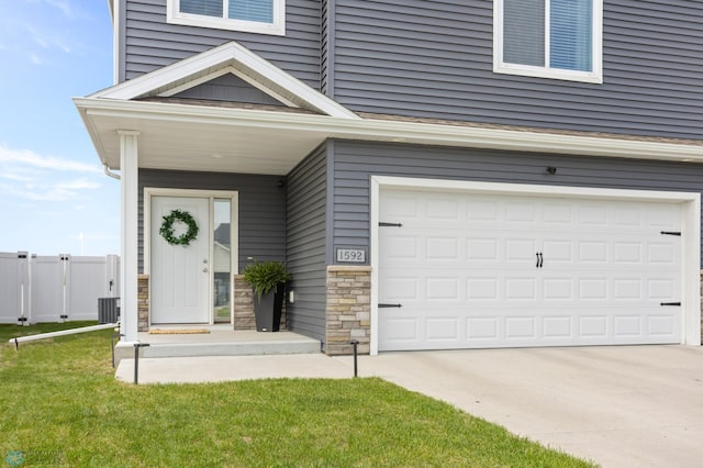 1592 69th Ave S, Fargo, ND 58104 - view of front of property featuring concrete driveway, stone siding, and a garage