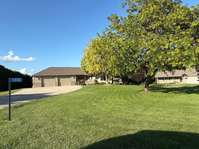 53030 254th Ave, Plainview Twp, MN 55964 - view of green lawn featuring an attached garage and concrete driveway