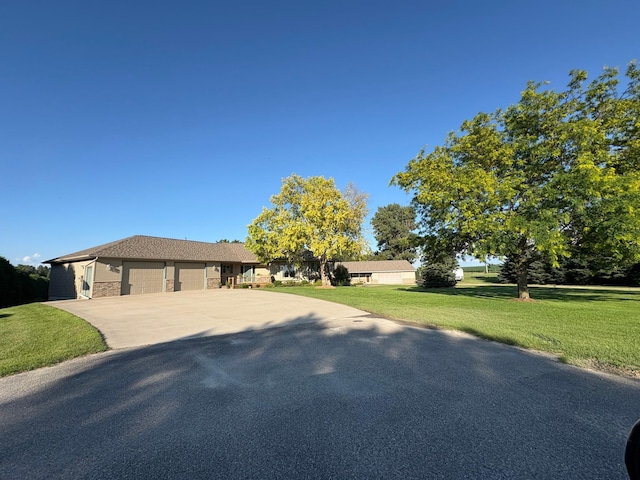 53030 254th Ave, Plainview Twp, MN 55964 - ranch-style home with a garage, a front lawn, concrete driveway, and stone siding