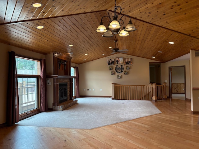 53030 254th Ave, Plainview Twp, MN 55964 - unfurnished living room with vaulted ceiling, hardwood / wood-style floors, a chandelier, a fireplace, and recessed lighting