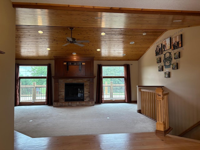 53030 254th Ave, Plainview Twp, MN 55964 - unfurnished living room with plenty of natural light, a ceiling fan, vaulted ceiling, a brick fireplace, and carpet