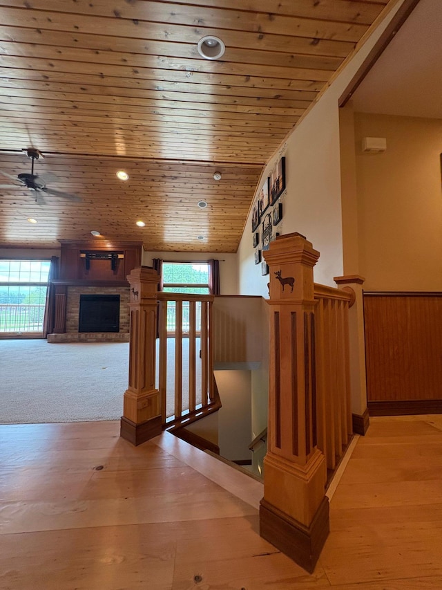 53030 254th Ave, Plainview Twp, MN 55964 - staircase featuring wood ceiling, a brick fireplace, a ceiling fan, and wood-type flooring