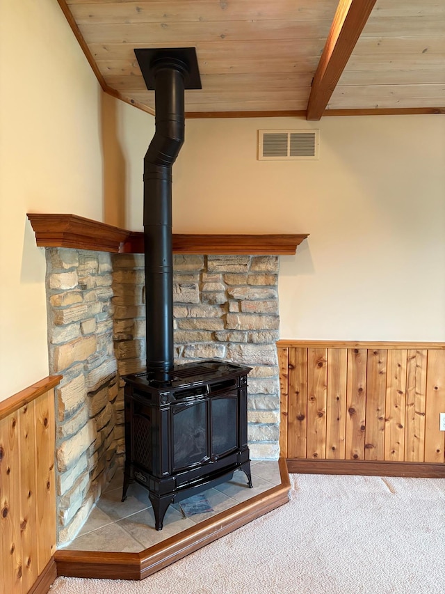53030 254th Ave, Plainview Twp, MN 55964 - detailed view of a wood stove, carpet, a wood ceiling with exposed beams, ornamental molding, and wainscoting