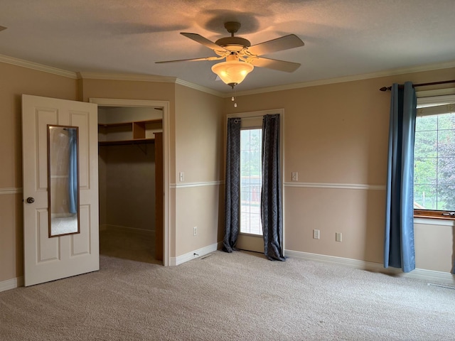 53030 254th Ave, Plainview Twp, MN 55964 - unfurnished bedroom with crown molding, carpet, a closet, and a ceiling fan