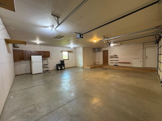 53030 254th Ave, Plainview Twp, MN 55964 - garage with freestanding refrigerator and a garage door opener