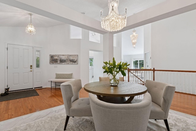 3725 Archer Ln N, Plymouth, MN 55446 - dining space with a chandelier, light wood-style floors, and a high ceiling