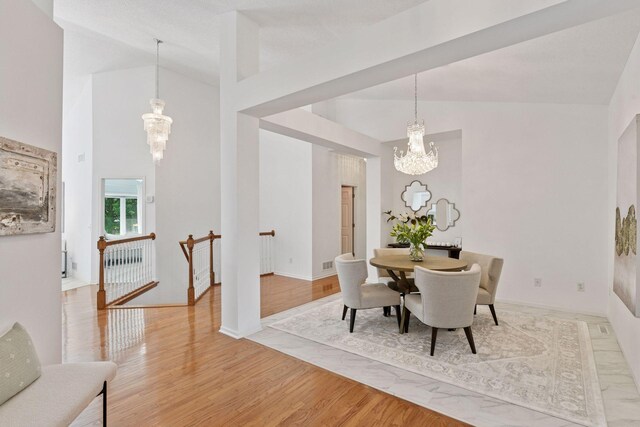 3725 Archer Ln N, Plymouth, MN 55446 - dining area with a chandelier, light wood-style floors, and vaulted ceiling