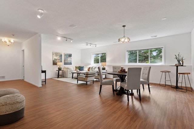 3725 Archer Ln N, Plymouth, MN 55446 - dining area featuring a chandelier, wood finished floors, and rail lighting