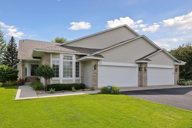 3725 Archer Ln N, Plymouth, MN 55446 - view of front of home featuring brick siding, a garage, asphalt driveway, and a front yard