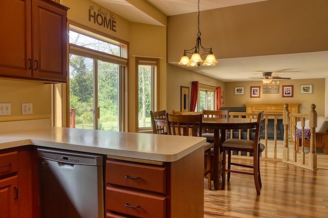 20730 Glenbrook Ave N, Forest Lake, MN 55025 - kitchen with stainless steel dishwasher, a peninsula, light countertops, and light wood-style floors