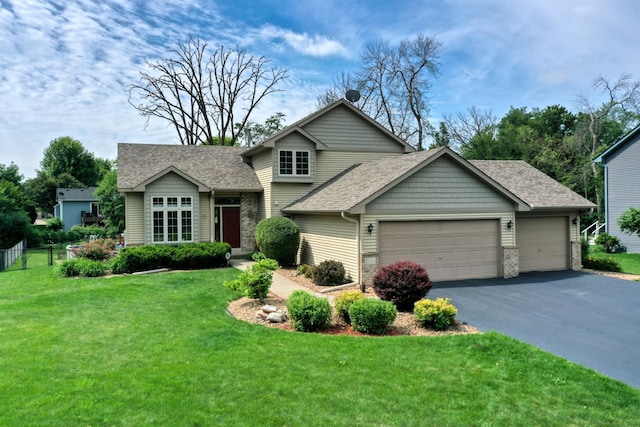 20730 Glenbrook Ave N, Forest Lake, MN 55025 - tri-level home featuring an attached garage, a shingled roof, asphalt driveway, and a front yard