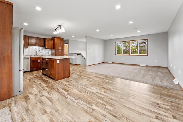 55170 Forest Blvd, Rush City, MN 55069 - kitchen with light countertops, light wood finished floors, recessed lighting, a kitchen island, and freestanding refrigerator