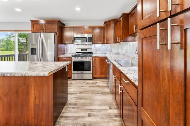 55170 Forest Blvd, Rush City, MN 55069 - kitchen featuring stainless steel appliances, light wood finished floors, recessed lighting, decorative backsplash, and brown cabinets
