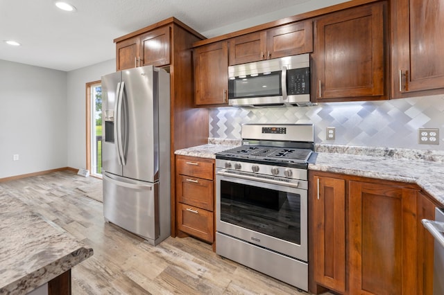 55170 Forest Blvd, Rush City, MN 55069 - kitchen with appliances with stainless steel finishes, light wood-style flooring, tasteful backsplash, recessed lighting, and brown cabinetry
