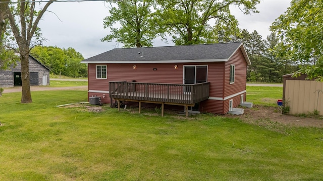 55170 Forest Blvd, Rush City, MN 55069 - rear view of property with a wooden deck, a yard, a shingled roof, and a storage shed