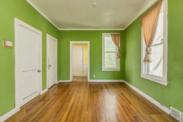1111 Como Pl, Saint Paul, MN 55103 - unfurnished room with wood-type flooring, a smoke detector, plenty of natural light, and ornamental molding