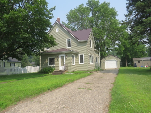 904 12th St N, Benson, MN 56215 - view of front facade with driveway, a garage, an outdoor structure, and a chimney