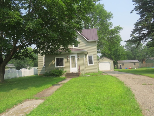 904 12th St N, Benson, MN 56215 - view of front of property with concrete driveway, an outdoor structure, a garage, and a metal roof