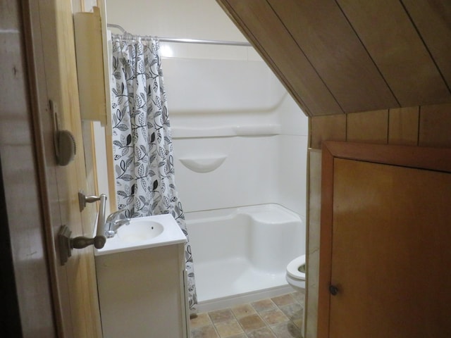 904 12th St N, Benson, MN 56215 - bathroom featuring curtained shower, vanity, and stone finish flooring