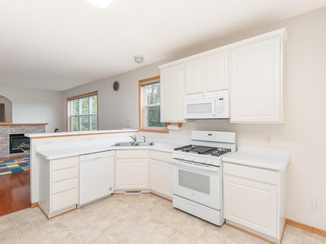 17625 48th Pl N, Plymouth, MN 55446 - kitchen with white appliances, light countertops, a fireplace, white cabinetry, and a peninsula