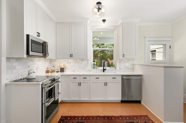2636 Harriet Ave, Minneapolis, MN 55408 - kitchen featuring stainless steel appliances, tasteful backsplash, white cabinetry, light countertops, and ornamental molding