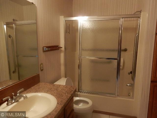 2169 78th Ct E, Inver Grove Heights, MN 55077 - full bathroom featuring vanity and combined bath / shower with glass door