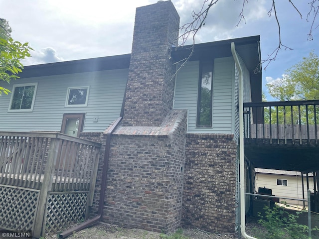 2169 78th Ct E, Inver Grove Heights, MN 55077 - rear view of property with a chimney and a wooden deck