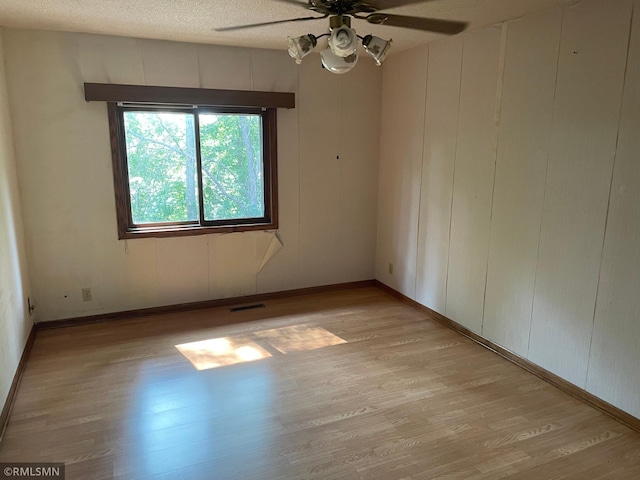 2169 78th Ct E, Inver Grove Heights, MN 55077 - unfurnished room with a ceiling fan, light wood finished floors, and a textured ceiling
