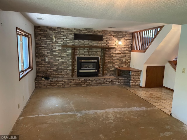 2169 78th Ct E, Inver Grove Heights, MN 55077 - unfurnished living room with a fireplace, a textured ceiling, and stairway
