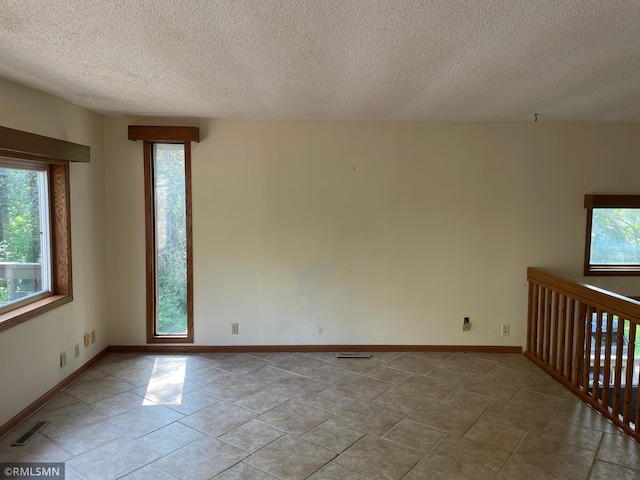 2169 78th Ct E, Inver Grove Heights, MN 55077 - unfurnished room with healthy amount of natural light and a textured ceiling