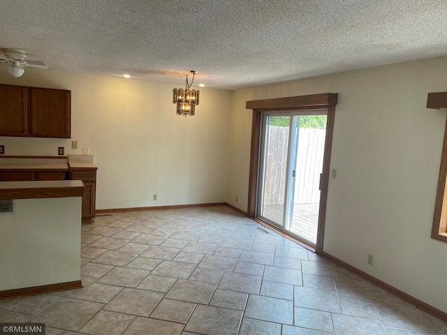 2169 78th Ct E, Inver Grove Heights, MN 55077 - unfurnished living room with a textured ceiling and a chandelier