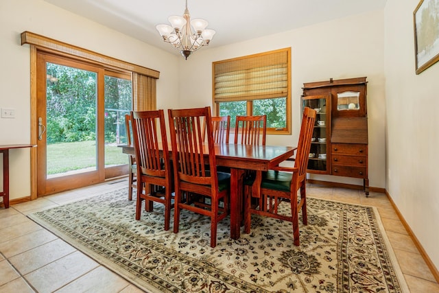W5136 Hale Ct, Farmington Twp, WI 54636 - tiled dining room featuring a chandelier and baseboards