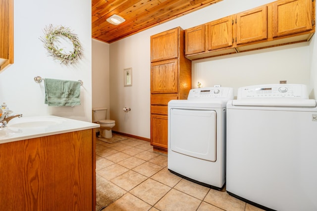 W5136 Hale Ct, Farmington Twp, WI 54636 - washroom featuring washing machine and dryer, wooden ceiling, and light tile patterned flooring