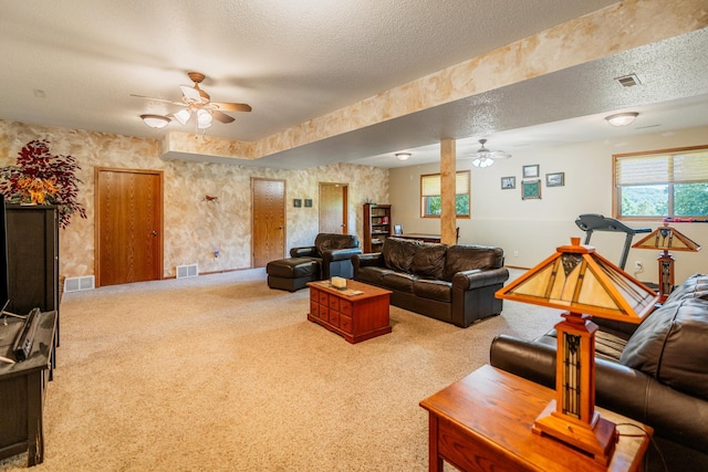 W5136 Hale Ct, Farmington Twp, WI 54636 - carpeted living area featuring a ceiling fan and a textured ceiling