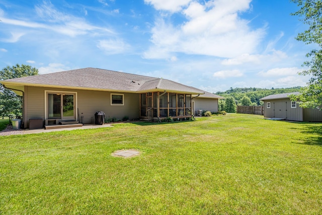 W5136 Hale Ct, Farmington Twp, WI 54636 - rear view of house with a sunroom, a shed, and a patio