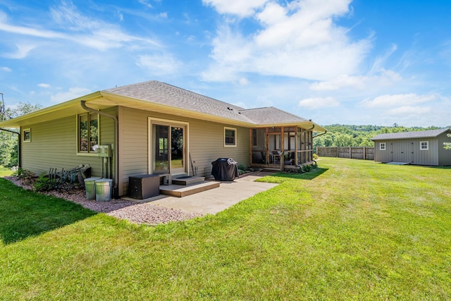 W5136 Hale Ct, Farmington Twp, WI 54636 - back of property featuring a sunroom, a patio, an outdoor structure, and roof with shingles