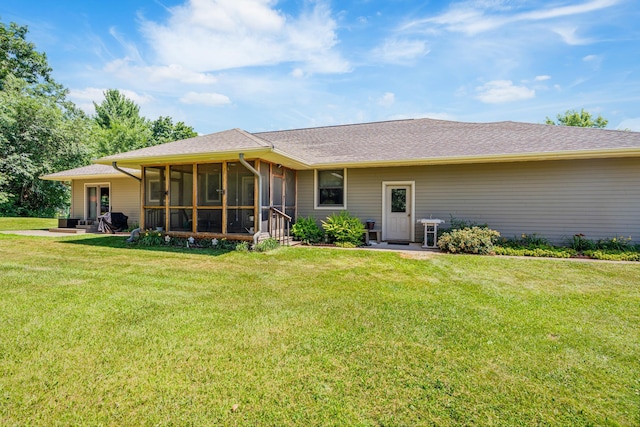 W5136 Hale Ct, Farmington Twp, WI 54636 - rear view of house featuring a sunroom, a yard, and a shingled roof