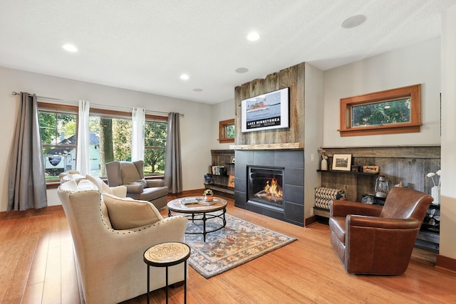 2794 Casco Point Rd, Orono, MN 55391 - living area featuring a tile fireplace, light wood-style floors, and recessed lighting