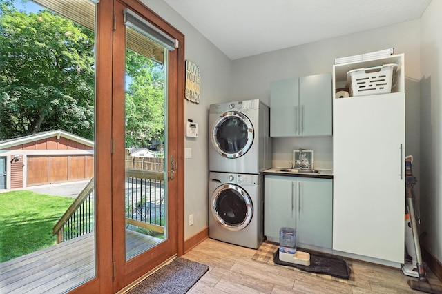 2794 Casco Point Rd, Orono, MN 55391 - laundry room with cabinet space, stacked washer / dryer, and light wood-type flooring