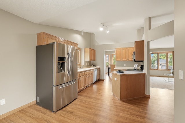 10374 61st St NE, Albertville, MN 55301 - kitchen featuring appliances with stainless steel finishes, vaulted ceiling, light countertops, light wood-style flooring, and track lighting