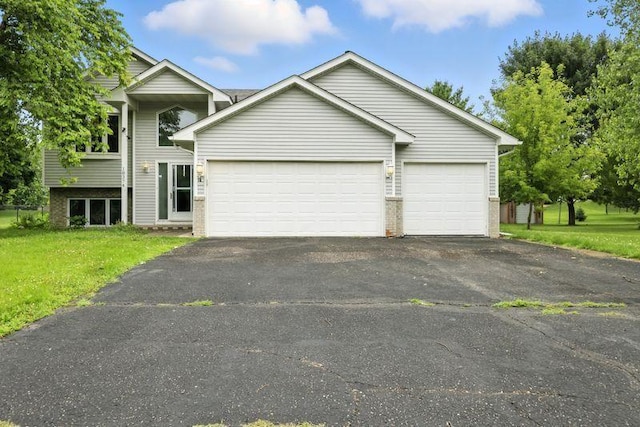 10374 61st St NE, Albertville, MN 55301 - view of front facade featuring asphalt driveway, a front lawn, a garage, and brick siding
