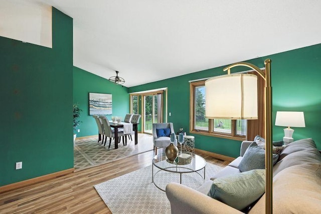 10374 61st St NE, Albertville, MN 55301 - living area featuring vaulted ceiling and wood finished floors