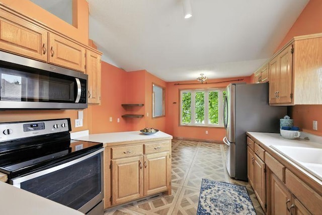 10374 61st St NE, Albertville, MN 55301 - kitchen featuring appliances with stainless steel finishes, vaulted ceiling, light countertops, light brown cabinets, and a peninsula