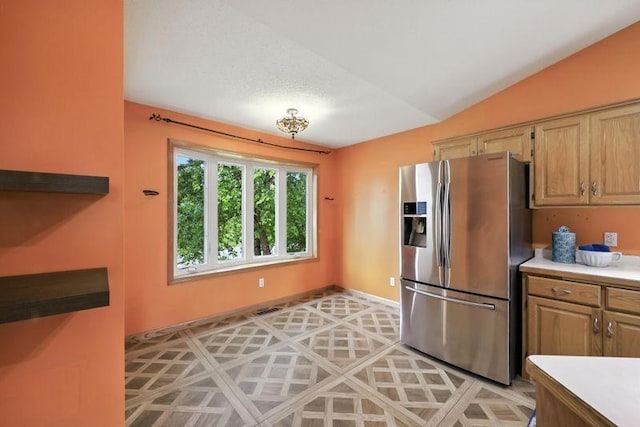 10374 61st St NE, Albertville, MN 55301 - kitchen featuring stainless steel fridge, light countertops, vaulted ceiling, and light floors