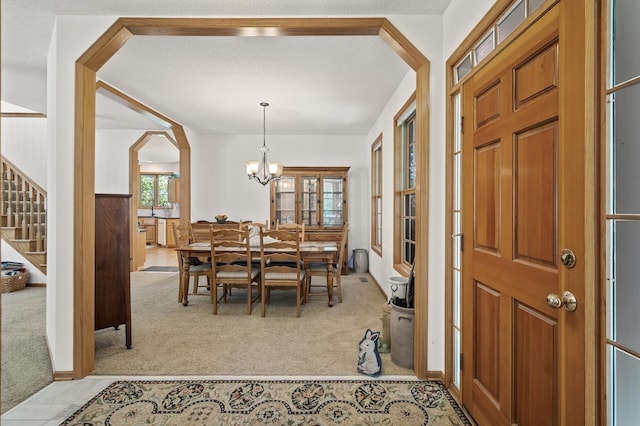 11691 115th St N, Grant, MN 55082 - dining room with carpet flooring, a chandelier, and stairs