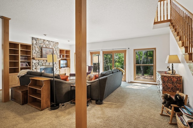 11691 115th St N, Grant, MN 55082 - carpeted living area with a textured ceiling, stairway, a fireplace, and built in features